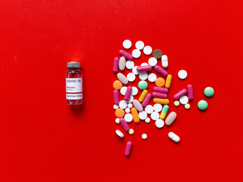 white and red labeled medication pill bottle